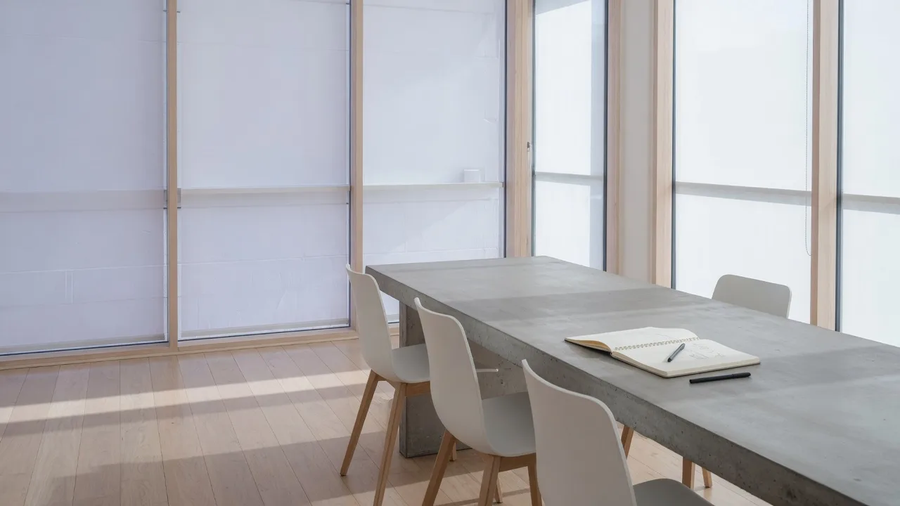 Bright minimal conference room with daylight and an open notebook — evaluation criteria for choosing a coach